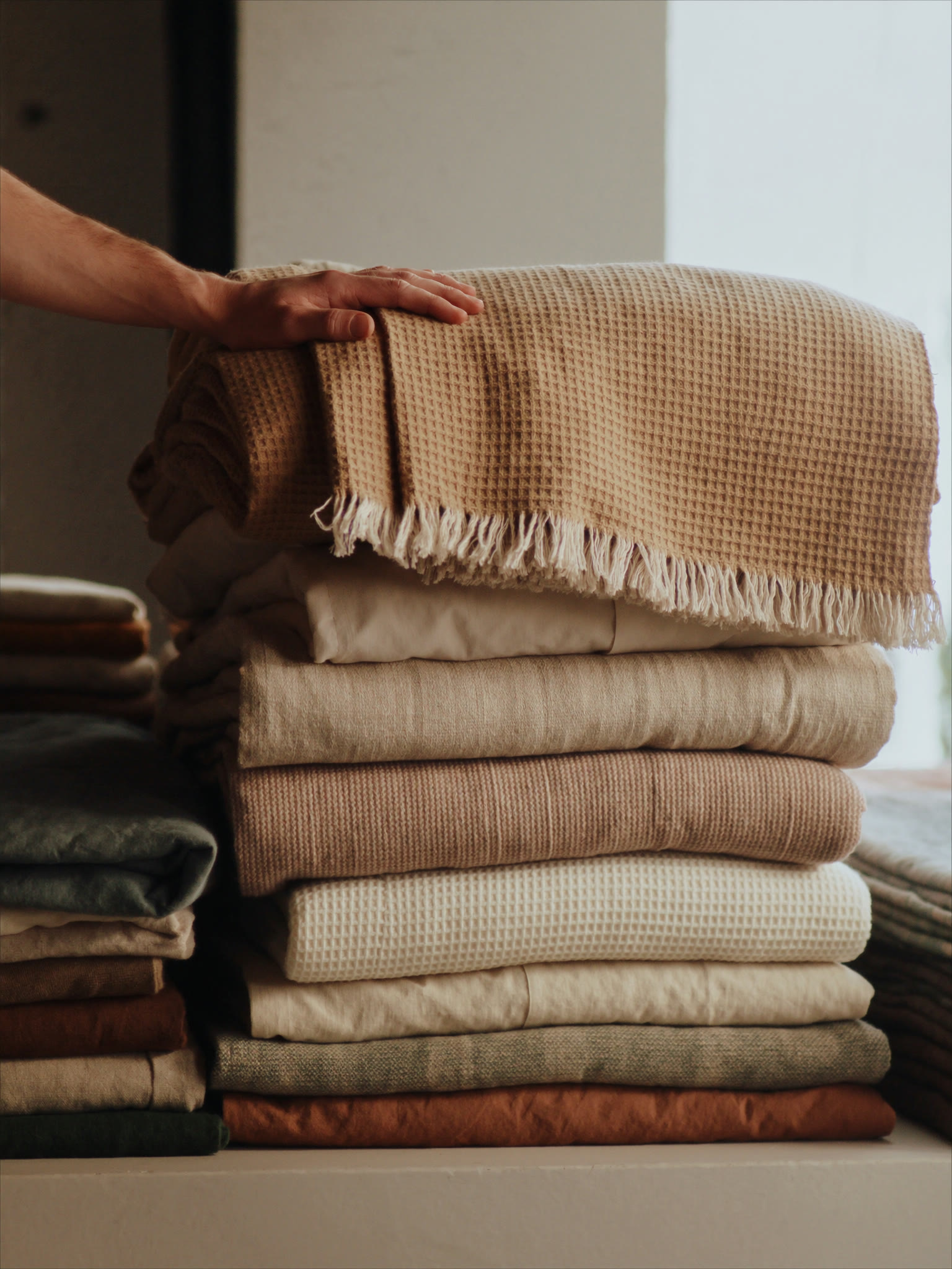 A stack of folded towels and throws